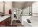 Bright bathroom featuring a soaking tub, glass shower, and wood vanity at 3031 W Cottonwood Ln, Phoenix, AZ 85045