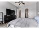 Primary bedroom features a ceiling fan, large dresser, and ensuite bathroom at 3031 W Cottonwood Ln, Phoenix, AZ 85045