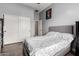 Bedroom with a sliding door closet, gray walls, and wood floors at 3031 W Cottonwood Ln, Phoenix, AZ 85045