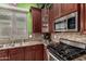 Beautiful kitchen with stainless steel appliances, stone countertops, and custom cabinets at 3031 W Cottonwood Ln, Phoenix, AZ 85045