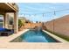 Backyard pool with a rock waterfall and manicured landscaping at 3031 W Cottonwood Ln, Phoenix, AZ 85045