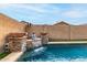 A serene pool showcases a Buddha statue water feature with stone accents for a tranquil backyard oasis at 3031 W Cottonwood Ln, Phoenix, AZ 85045