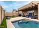 An inviting pool area features a covered patio with seating, a hammock, and stylish outdoor lighting at 3031 W Cottonwood Ln, Phoenix, AZ 85045