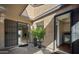 Inviting courtyard entrance featuring an open doorway, tiled floors, and a view of the living room beyond at 3033 N 37Th St # 14, Phoenix, AZ 85018