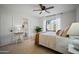 Bright main bedroom with neutral tones, ceiling fan, and a view into the en-suite bathroom at 3033 N 37Th St # 14, Phoenix, AZ 85018