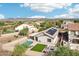 Stunning aerial view of a home with a pool, solar panels, artificial grass and desert landscaping at 30480 N 128Th Ln, Peoria, AZ 85383