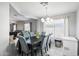 Elegant dining room featuring a chandelier, stylish chairs, and ample natural light from the window at 30480 N 128Th Ln, Peoria, AZ 85383