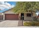 Charming home featuring a well-maintained yard, desert landscaping, and a prominent shade tree at 30480 N 128Th Ln, Peoria, AZ 85383