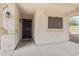 Inviting covered front porch with a security screen door and a view of the surrounding landscape at 30480 N 128Th Ln, Peoria, AZ 85383