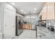 A stainless steel fridge shines in this kitchen with a mosaic backsplash and ample counter space at 30480 N 128Th Ln, Peoria, AZ 85383