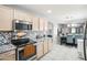 Light wood cabinets and modern stainless appliances add style to this cozy kitchen and dining area at 30480 N 128Th Ln, Peoria, AZ 85383