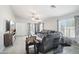 Cozy living room with tile floors, a ceiling fan, and comfortable seating, perfect for relaxation and entertainment at 30480 N 128Th Ln, Peoria, AZ 85383