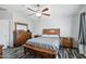 A full view of this main bedroom with wood floors, wood furnishings, and a gray color palette at 30480 N 128Th Ln, Peoria, AZ 85383