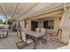 Relaxing covered patio with travertine tile, dining set, grill and plenty of shade at 30480 N 128Th Ln, Peoria, AZ 85383