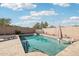 Sparkling pool with a tanning ledge in a private backyard with desert landscaping at 30480 N 128Th Ln, Peoria, AZ 85383