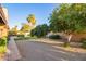 Spacious backyard featuring a large gravel area, citrus trees, well-maintained lawn, and manicured landscaping at 315 W Sonoma Dr, Litchfield Park, AZ 85340