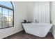 Modern white soaking tub in the bathroom with a window view at 315 W Sonoma Dr, Litchfield Park, AZ 85340