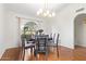 A formal dining room features hardwood floors, an arched window, and modern light fixtures at 315 W Sonoma Dr, Litchfield Park, AZ 85340