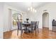 A formal dining room features hardwood floors, an arched window, and modern light fixtures at 315 W Sonoma Dr, Litchfield Park, AZ 85340