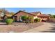 Single-story home with tile roof, xeriscaped front yard, two car garage, and extended driveway at 315 W Sonoma Dr, Litchfield Park, AZ 85340