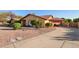 Single-story home with tile roof, xeriscaped front yard, two car garage, and extended driveway at 315 W Sonoma Dr, Litchfield Park, AZ 85340