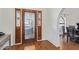 Elegant foyer with hardwood floors, decorative glass front door, and arched doorway to the dining room at 315 W Sonoma Dr, Litchfield Park, AZ 85340