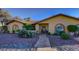 Attractive home with a tidy front yard featuring desert landscaping, a stone walkway, and mature plants at 315 W Sonoma Dr, Litchfield Park, AZ 85340