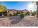 Charming single-story home features a tile roof, arched windows, and a beautifully xeriscaped front yard with mature landscaping at 315 W Sonoma Dr, Litchfield Park, AZ 85340