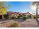 Charming single-story home features a tile roof, arched windows, and a beautifully xeriscaped front yard with mature landscaping at 315 W Sonoma Dr, Litchfield Park, AZ 85340