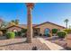 Charming single-story home features a tile roof, arched windows, and a beautifully xeriscaped front yard with mature landscaping at 315 W Sonoma Dr, Litchfield Park, AZ 85340