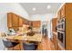 An open kitchen with breakfast bar, tile countertops, oak cabinetry, and stainless steel appliances at 315 W Sonoma Dr, Litchfield Park, AZ 85340