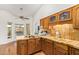 Charming kitchen with tile countertops, wood cabinets, stainless steel sink, and a view of the outdoors at 315 W Sonoma Dr, Litchfield Park, AZ 85340