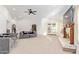 Spacious living room with a decorative fireplace, ceiling fan, and sliding doors to outdoor at 315 W Sonoma Dr, Litchfield Park, AZ 85340