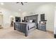 A bedroom with an oversized headboard, neutral walls, and access to the hallway at 315 W Sonoma Dr, Litchfield Park, AZ 85340