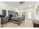 A bedroom with an oversized headboard, neutral walls, and access to the outdoors at 315 W Sonoma Dr, Litchfield Park, AZ 85340