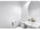 Modern powder room with a pedestal sink and round mirror at 342 E Backman St, San Tan Valley, AZ 85140