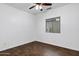 Bright bedroom featuring wood-look flooring, a ceiling fan, and a window bringing in natural light at 342 E Backman St, San Tan Valley, AZ 85140