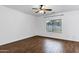 Bright bedroom features a ceiling fan, wood-look flooring, and a window bringing in natural light at 342 E Backman St, San Tan Valley, AZ 85140