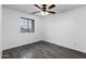 Bedroom with light gray wood floors, a ceiling fan, and a large window with a view at 342 E Backman St, San Tan Valley, AZ 85140