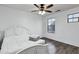 Bedroom with a queen-size bed, a fan and two windows offering natural light at 342 E Backman St, San Tan Valley, AZ 85140