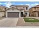 Charming two-story home with a well-maintained front yard and two car garage at 342 E Backman St, San Tan Valley, AZ 85140