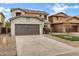 Two-story home with a two car garage and low maintenance front yard at 342 E Backman St, San Tan Valley, AZ 85140