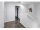 Bright upstairs hallway with wood floors and neutral paint at 342 E Backman St, San Tan Valley, AZ 85140