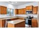 Kitchen with ample wood cabinetry, stainless steel appliances, and a central island for food prep at 342 E Backman St, San Tan Valley, AZ 85140