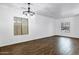 Spacious living area featuring new flooring, two large windows, and a modern chandelier at 342 E Backman St, San Tan Valley, AZ 85140