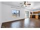 Open-concept living room featuring wood-look flooring, backyard access, and flows into the kitchen at 342 E Backman St, San Tan Valley, AZ 85140