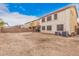 View of the expansive backyard with fence, patio, and air conditioning units at 38274 N Tumbleweed Ln, San Tan Valley, AZ 85140