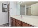 Functional bathroom with a single sink vanity, a large mirror, and a walk-in shower at 38274 N Tumbleweed Ln, San Tan Valley, AZ 85140