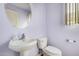 Powder room with a pedestal sink, toilet, and framed mirror at 38274 N Tumbleweed Ln, San Tan Valley, AZ 85140