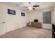 Bedroom with neutral carpet, ceiling fan, dresser and minimal decor, offering a blank canvas at 38274 N Tumbleweed Ln, San Tan Valley, AZ 85140